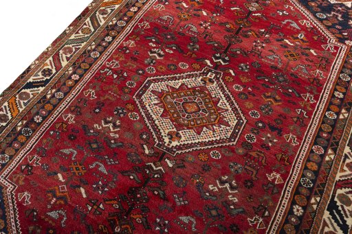 Backside of handmade 2000s Shiraz rug showing knot structure and weave density