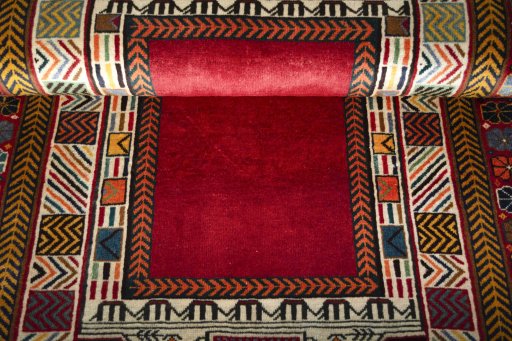 Corner detail of 2000s Shiraz rug showing border pattern and Wool pile