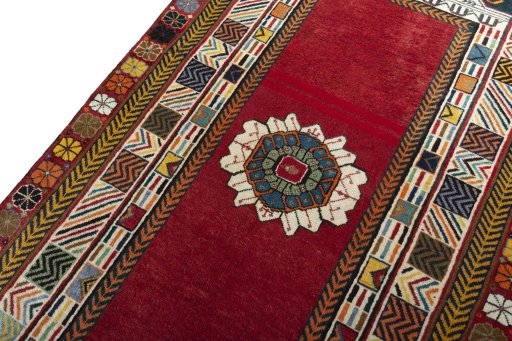 Backside of handmade 2000s Shiraz rug showing knot structure and weave density