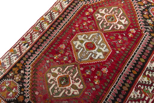 Backside of handmade 2000s Shiraz rug showing knot structure and weave density