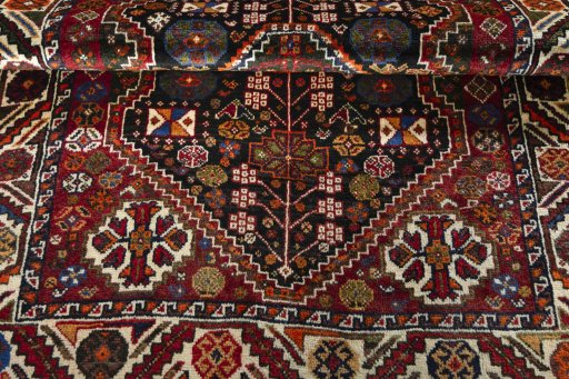 Corner detail of 2000s Shiraz rug showing border pattern and Wool pile