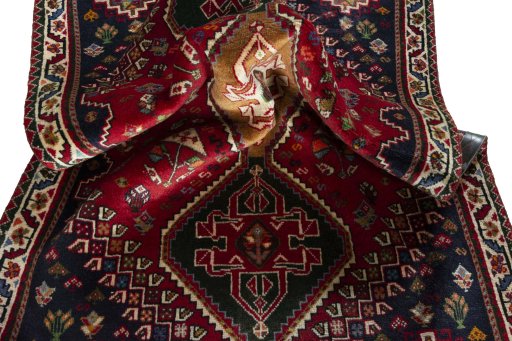 Corner detail of 2000s Shiraz rug showing border pattern and Wool pile