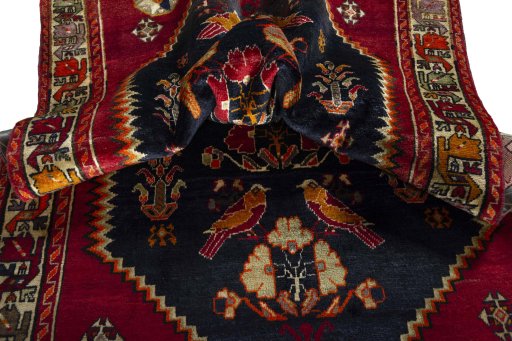 Corner detail of 2000s Shiraz rug showing border pattern and Wool pile