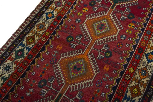 Backside of handmade 2000s Shiraz rug showing knot structure and weave density