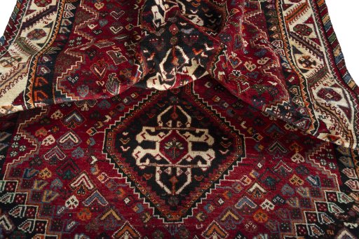 Corner detail of 2000s Shiraz rug showing border pattern and Wool pile
