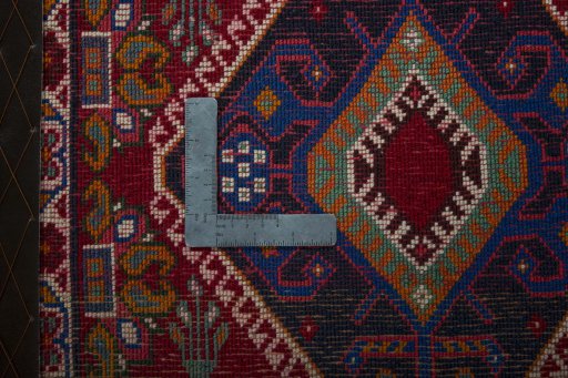 Backside of handmade 2000s Shiraz rug showing knot structure and weave density