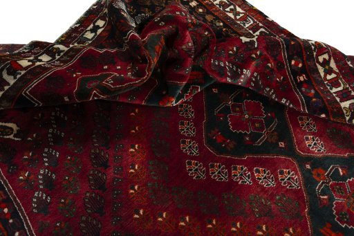 Corner detail of 2000s Shiraz rug showing border pattern and Wool pile