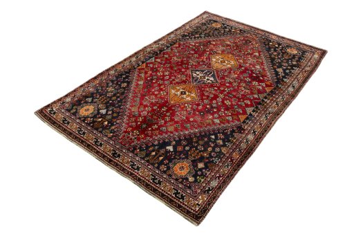 Corner detail of 2000s Shiraz rug showing border pattern and Wool pile
