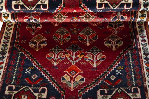 Corner detail of 2000s Shiraz rug showing border pattern and Wool pile