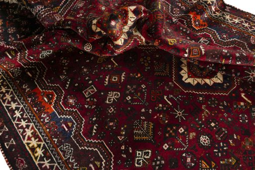 Corner detail of 2000s Shiraz rug showing border pattern and Wool pile
