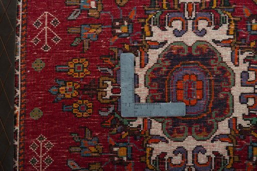 Backside of handmade 2000s Shiraz rug showing knot structure and weave density