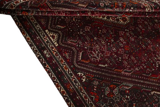 Corner detail of 2000s Shiraz rug showing border pattern and Wool pile