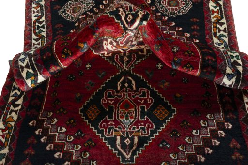 Corner detail of 2000s Shiraz rug showing border pattern and Wool pile