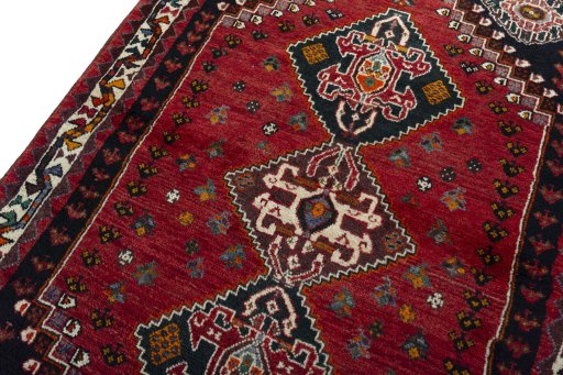Backside of handmade 2000s Shiraz rug showing knot structure and weave density