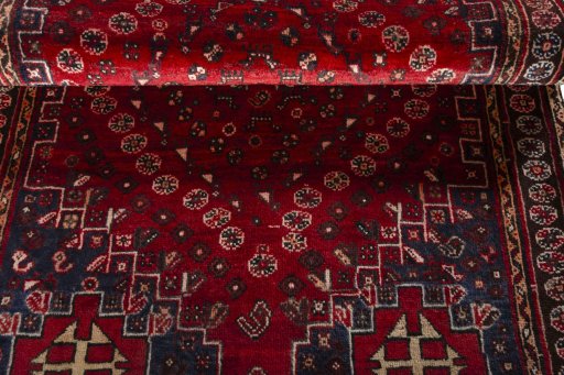 Corner detail of 2000s Shiraz rug showing border pattern and Wool pile