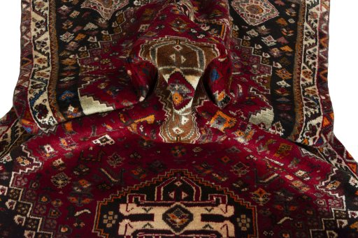 Corner detail of 2000s Shiraz rug showing border pattern and Wool pile