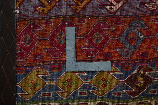 Backside of handmade 2000s Shiraz rug showing knot structure and weave density
