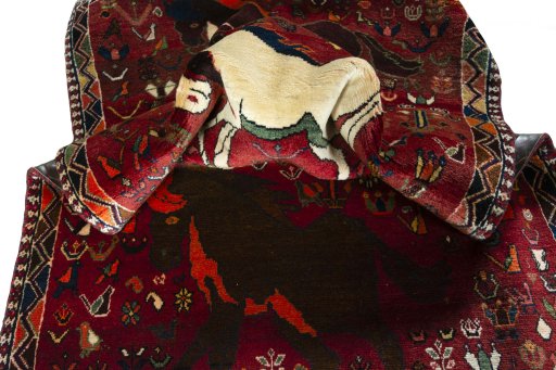 Corner detail of 2000s Shiraz rug showing border pattern and Wool pile