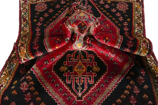 Corner detail of 2000s Shiraz rug showing border pattern and Wool pile