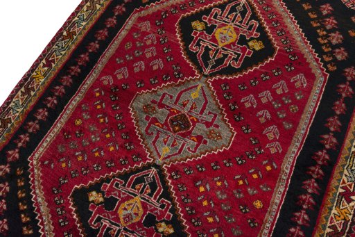Backside of handmade 2000s Shiraz rug showing knot structure and weave density