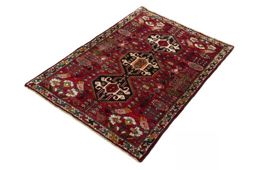 Corner detail of 2000s Shiraz rug showing border pattern and Wool pile