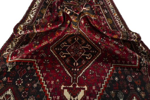 Corner detail of 2000s Shiraz rug showing border pattern and Wool pile