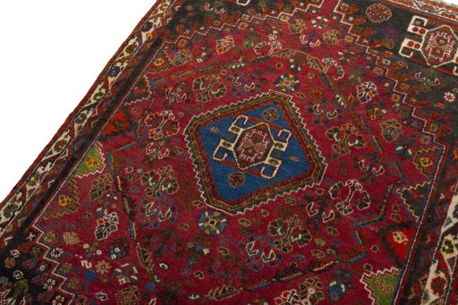 Backside of handmade 2000s Shiraz rug showing knot structure and weave density