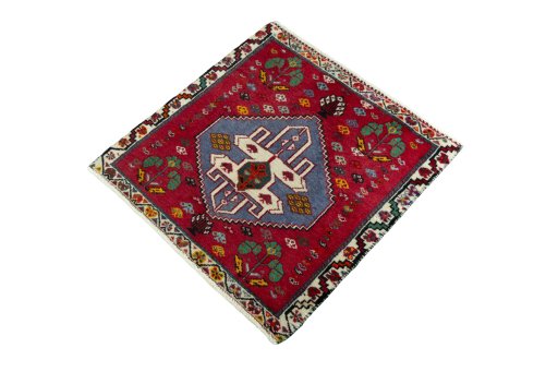 Corner detail of 2000s Shiraz rug showing border pattern and Wool pile