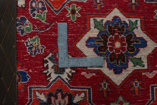 Backside of handmade 2000s Shiraz rug showing knot structure and weave density