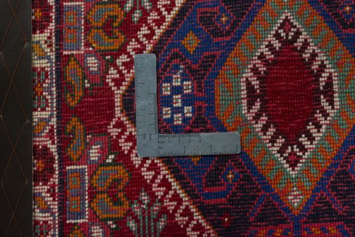 Backside of handmade 2000s Shiraz rug showing knot structure and weave density
