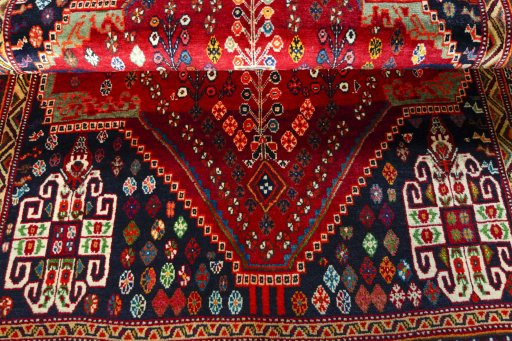 Corner detail of 2000s Shiraz rug showing border pattern and Wool pile