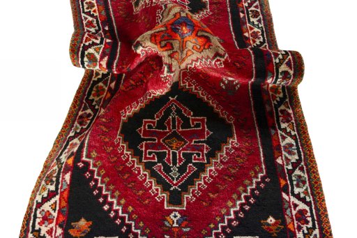 Corner detail of 2000s Shiraz rug showing border pattern and Wool pile