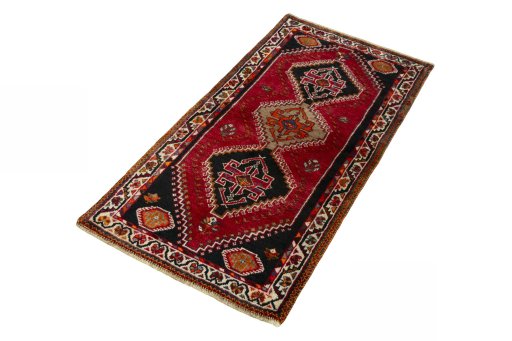Corner detail of 2000s Shiraz rug showing border pattern and Wool pile
