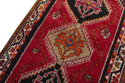 Backside of handmade 2000s Shiraz rug showing knot structure and weave density