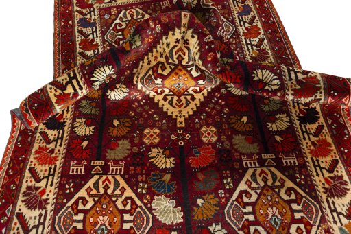 Corner detail of 2000s Shiraz rug showing border pattern and Wool pile