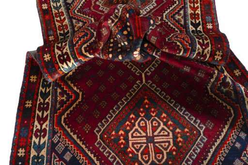 Corner detail of 2000s Shiraz rug showing border pattern and Wool pile
