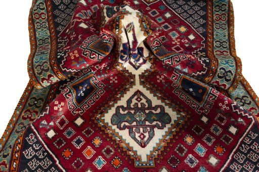 Corner detail of 2000s Shiraz rug showing border pattern and Wool pile
