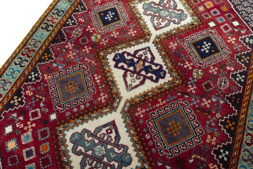 Backside of handmade 2000s Shiraz rug showing knot structure and weave density