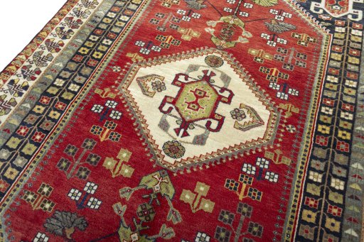Backside of handmade 2000s Shiraz rug showing knot structure and weave density