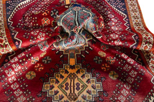 Corner detail of 2000s Shiraz rug showing border pattern and Wool pile