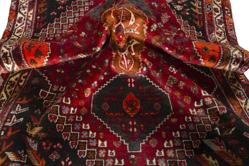 Corner detail of 2000s Shiraz rug showing border pattern and Wool pile