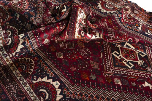 Corner detail of 2000s Shiraz rug showing border pattern and Wool pile