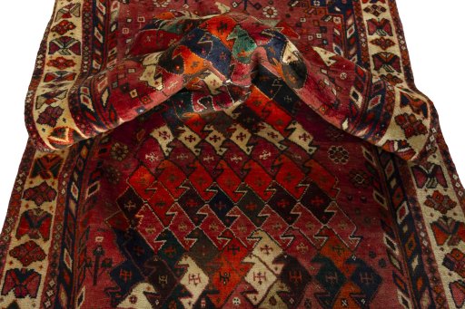 Corner detail of 2000s Shiraz rug showing border pattern and Wool pile