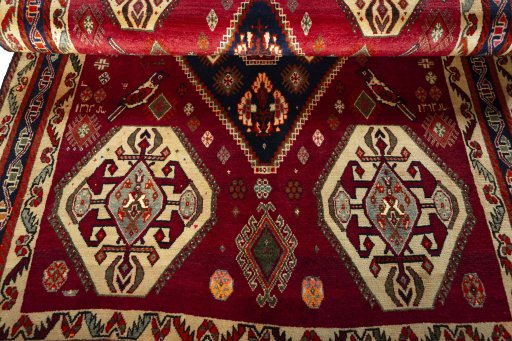 Corner detail of 2000s Shiraz rug showing border pattern and Wool pile