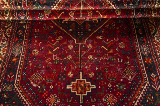 Corner detail of 2000s Shiraz rug showing border pattern and Wool pile