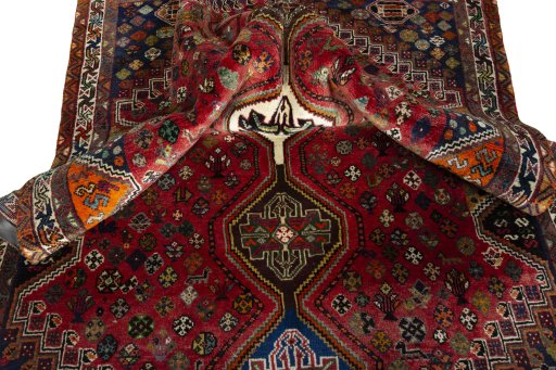 Corner detail of 2000s Shiraz rug showing border pattern and Wool pile