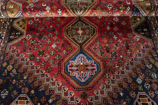 Full view of 2000s Shiraz rug from Iran / Persia, 243 × 160 cm in Red tones