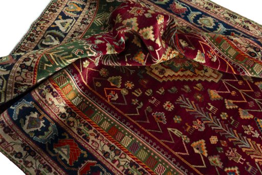 Surface texture of 2000s Shiraz rug with natural Wool and intricate pattern