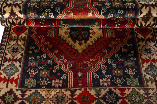 Corner detail of 2000s Shiraz rug showing border pattern and Wool pile
