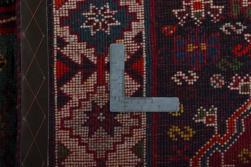 Surface texture of 2000s Shiraz rug with natural Wool and intricate pattern